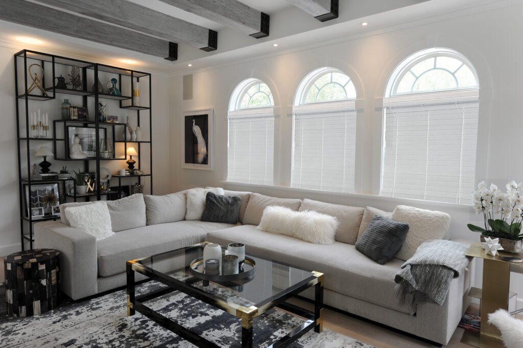 Window Blinds in Lake Keystone - FL being measured by an installer beside tall living room windows