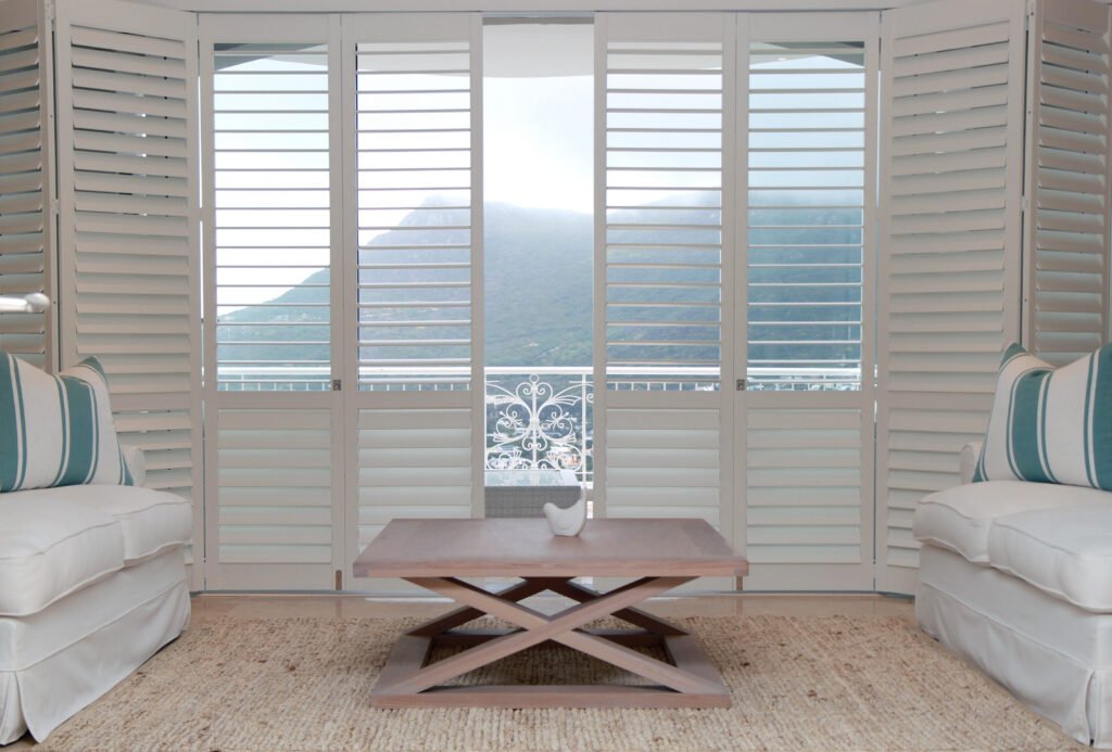 Installer adjusting Plantation Shutters in a Tierra Verde - FL bedroom for balanced light and privacy