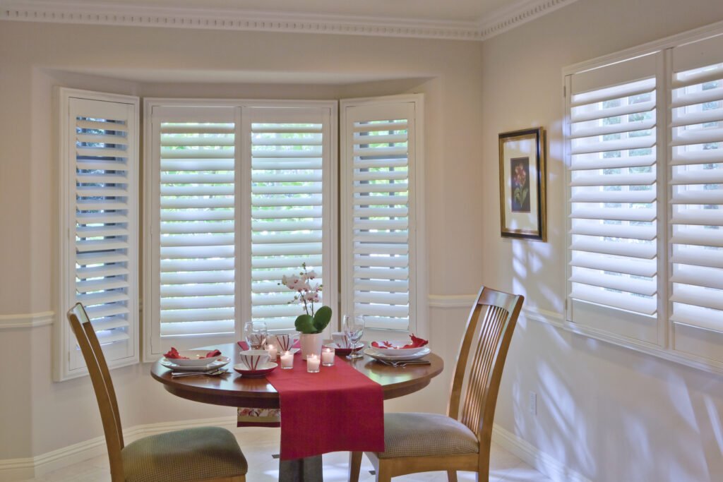 Plantation Shutters in Tierra Verde - FL being adjusted inside a bright waterfront family room