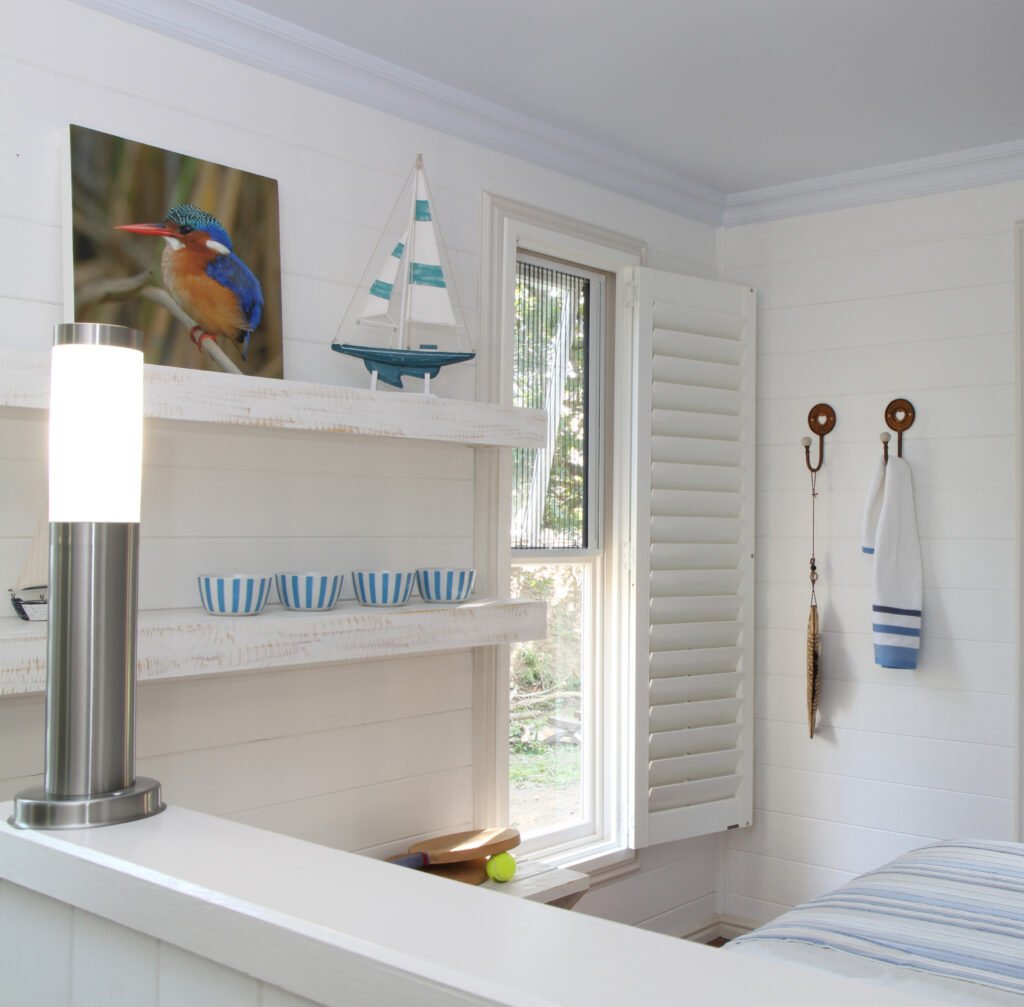 Designer adjusting Plantation Shutters inside a St. Pete Beach - FL condo to control afternoon light