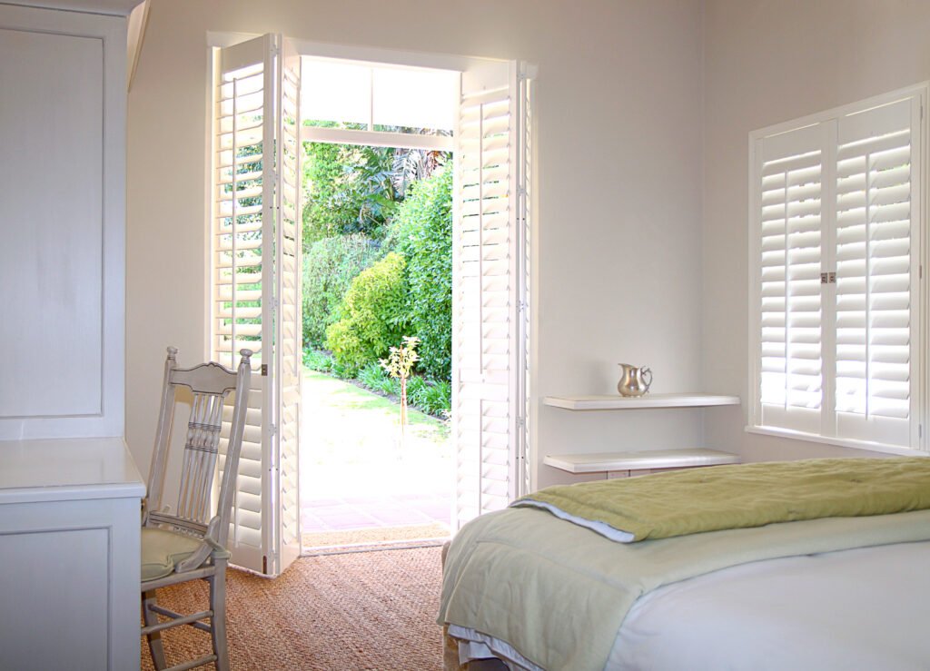 Plantation Shutters in St. Pete Beach - FL being installed across wide condo windows overlooking the coast